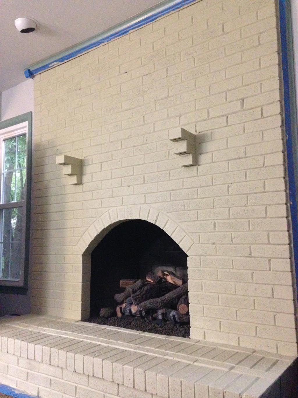 Distressed Painted Brick Fireplace